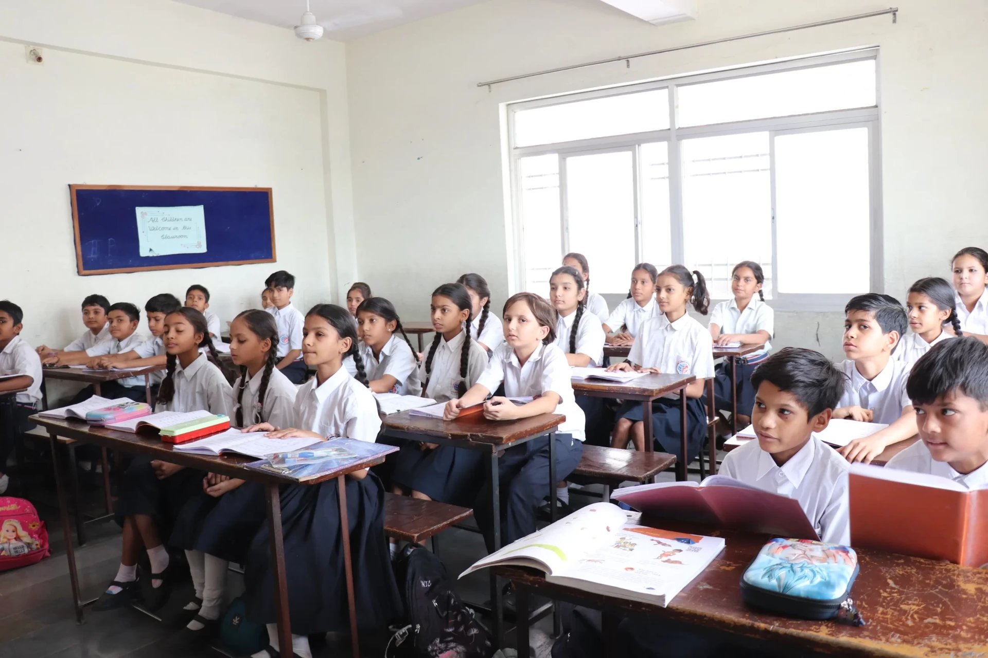 Happy students learning in a bright Stanvard School classroom